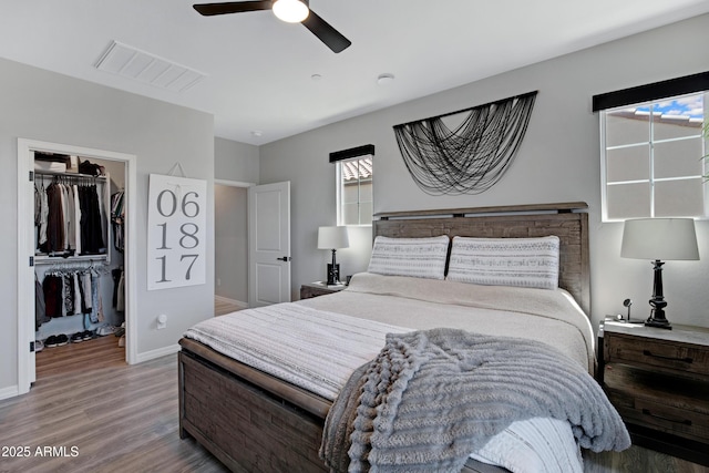 226 E Markwood Dr, Chandler, AZ 85286 - bedroom featuring wood finished floors, a spacious closet, baseboards, a ceiling fan, and a closet