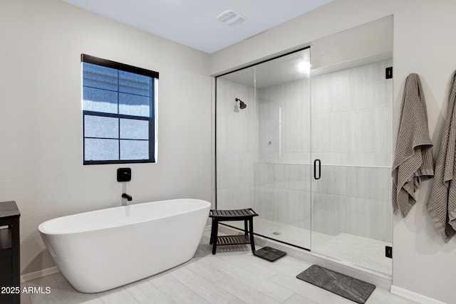 226 E Markwood Dr, Chandler, AZ 85286 - bathroom featuring a freestanding tub, a shower stall, vanity, and baseboards