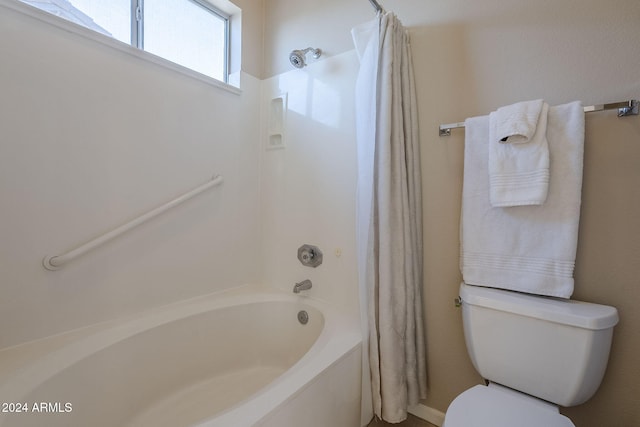 bathroom featuring toilet and shower / bathtub combination with curtain