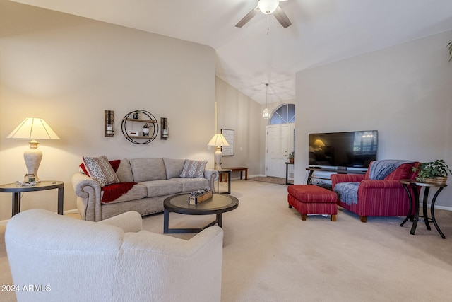 carpeted living room with ceiling fan and vaulted ceiling