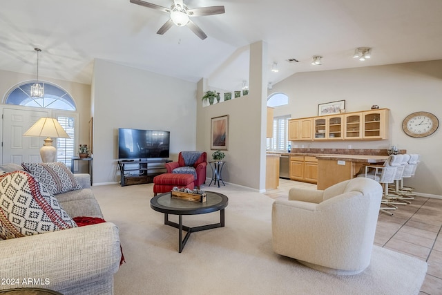 living room featuring ceiling fan, light colored carpet, and lofted ceiling