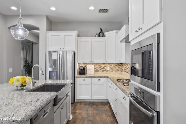 4302 E Cynthia St, Gilbert, AZ 85295 - kitchen with stainless steel appliances, white cabinets, dark wood-type flooring, light stone countertops, and recessed lighting