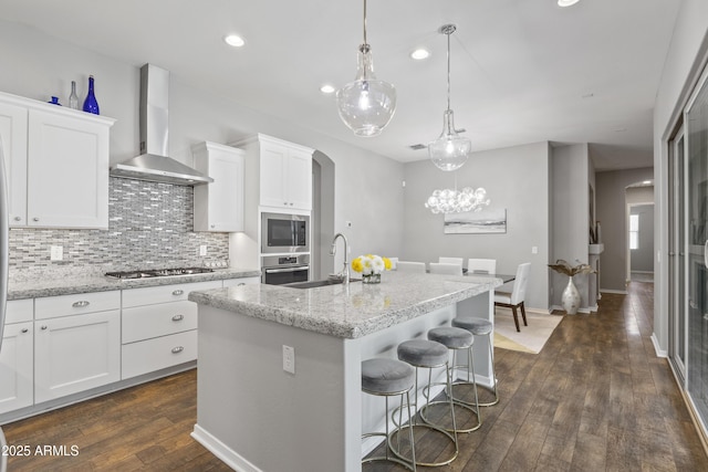 4302 E Cynthia St, Gilbert, AZ 85295 - kitchen with wall chimney range hood, appliances with stainless steel finishes, arched walkways, decorative backsplash, and dark wood-style floors