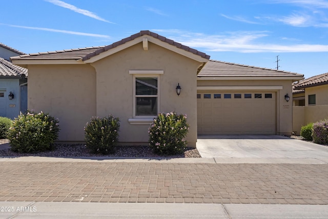 4302 E Cynthia St, Gilbert, AZ 85295 - view of front facade with a garage, concrete driveway, stucco siding, and a tiled roof