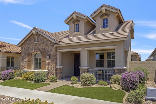 4302 E Cynthia St, Gilbert, AZ 85295 - view of front of house with stone siding, covered porch, a tiled roof, and stucco siding