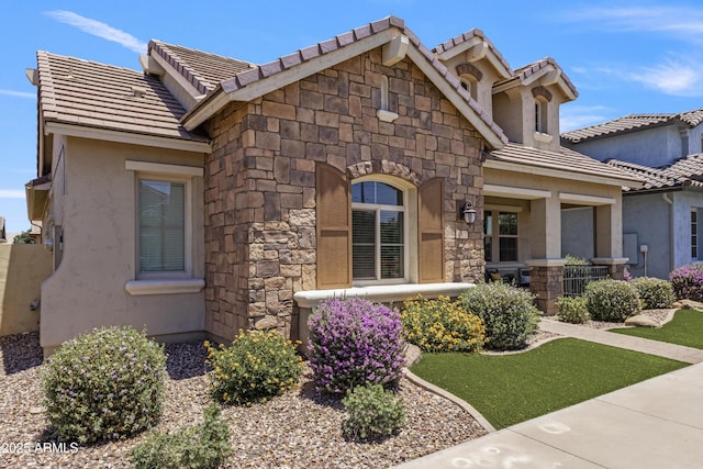4302 E Cynthia St, Gilbert, AZ 85295 - view of front of property with stone siding, a tile roof, and stucco siding
