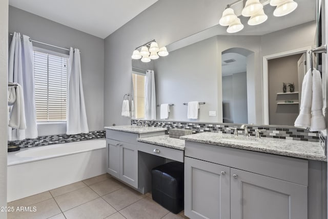 4302 E Cynthia St, Gilbert, AZ 85295 - bathroom featuring double vanity, a garden tub, tile patterned floors, and tasteful backsplash