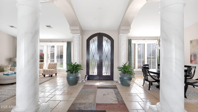 entryway with decorative columns and french doors