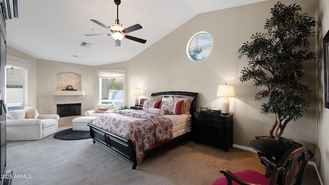 carpeted bedroom with ceiling fan, high vaulted ceiling, and a fireplace