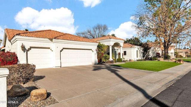 mediterranean / spanish-style house with a garage and a front lawn