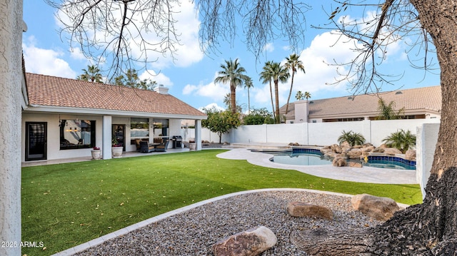 view of yard with a fenced in pool and a patio area