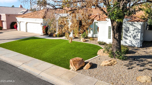 view of front of home featuring a garage and a front lawn