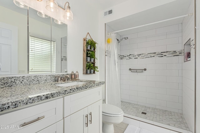 bathroom with vanity, curtained shower, and toilet