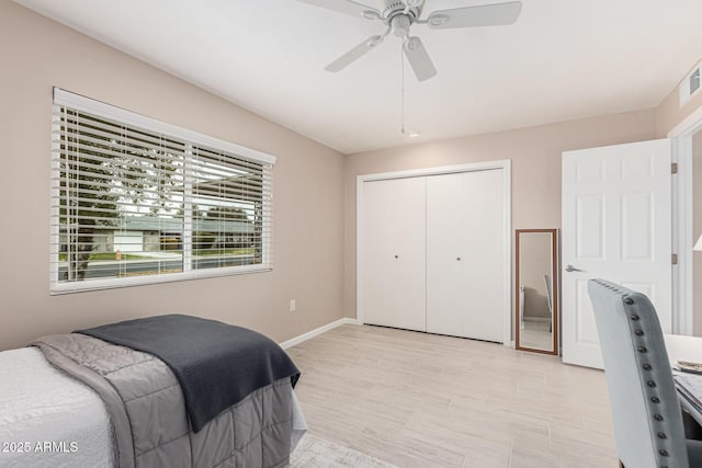 bedroom with ceiling fan and a closet