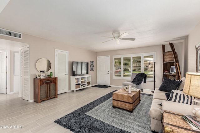 living room featuring ceiling fan and light hardwood / wood-style floors