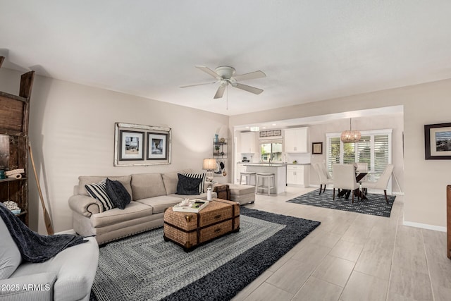 living room with ceiling fan and light hardwood / wood-style floors