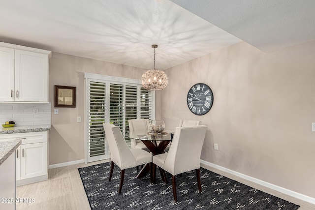 dining space featuring a notable chandelier