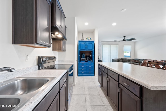 kitchen with light tile patterned floors, a center island, sink, stainless steel range with electric stovetop, and ceiling fan