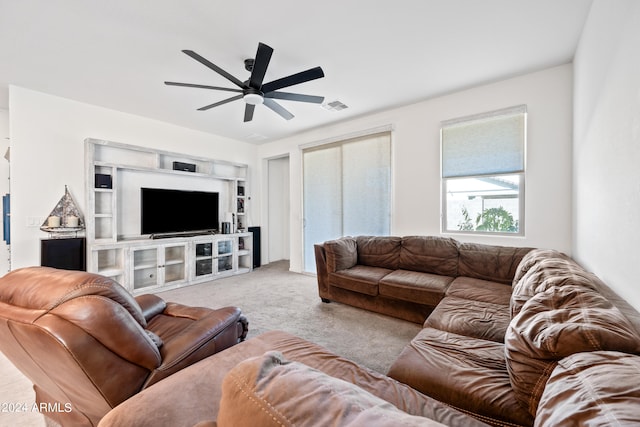 living room with ceiling fan and light colored carpet