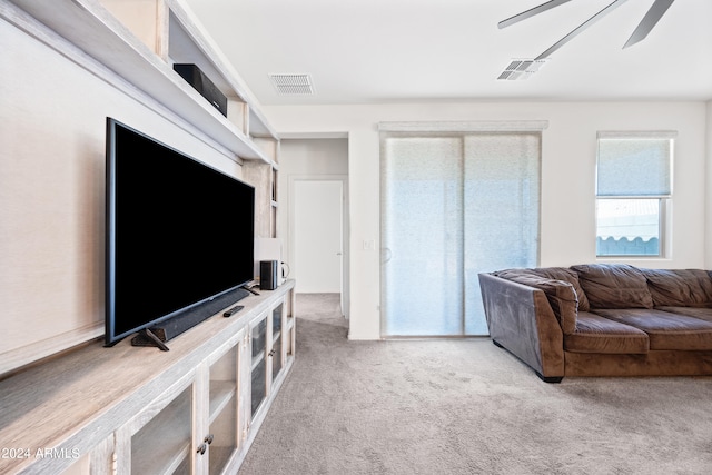 carpeted living room featuring ceiling fan