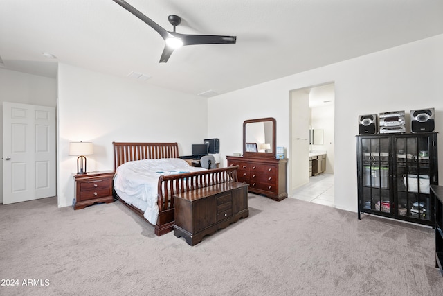 bedroom featuring ceiling fan, connected bathroom, and light carpet