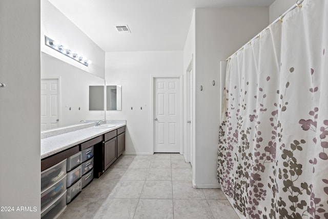 bathroom with tile patterned flooring, vanity, and a shower with curtain