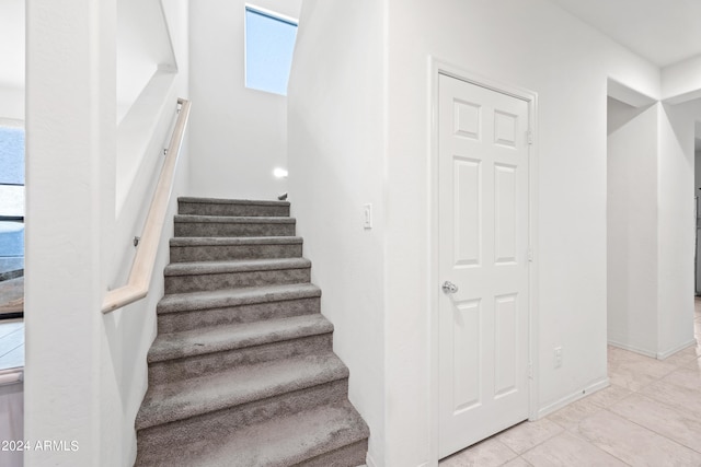 stairway featuring tile patterned floors