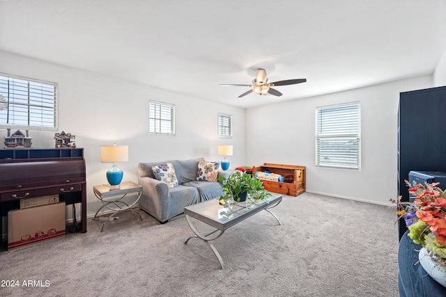 carpeted living room with ceiling fan