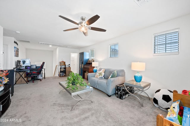 carpeted living room with a wealth of natural light and ceiling fan