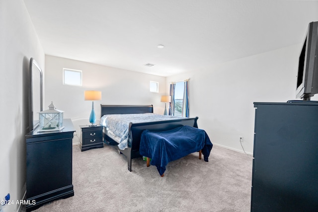 bedroom featuring multiple windows and carpet