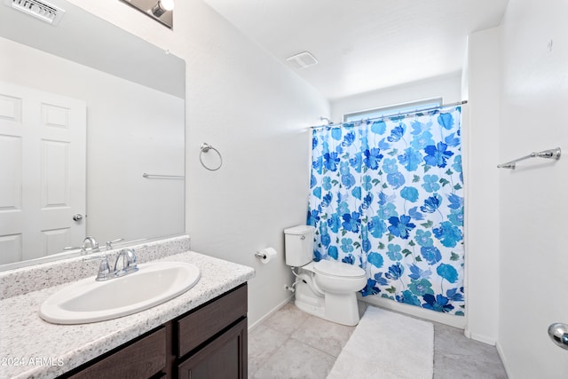 bathroom featuring vanity, toilet, a shower with shower curtain, and tile patterned flooring