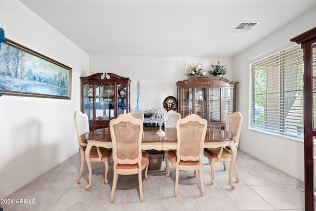 dining space featuring light tile patterned flooring