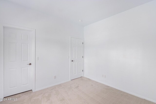 empty room with light colored carpet