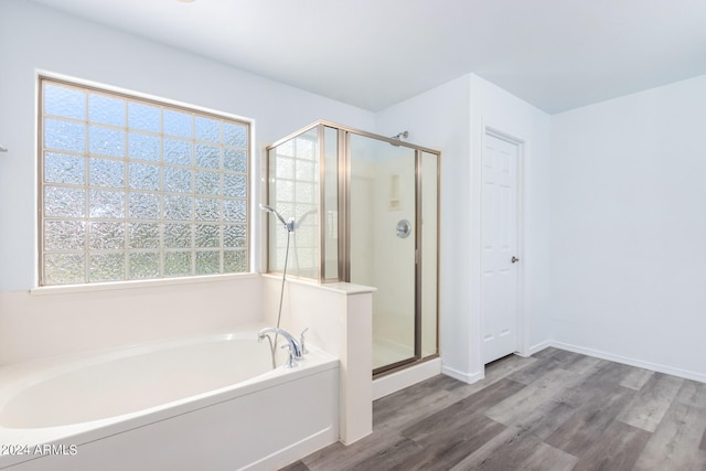 bathroom featuring separate shower and tub and wood-type flooring