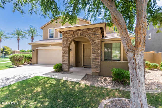 view of front of house featuring a garage and a front lawn