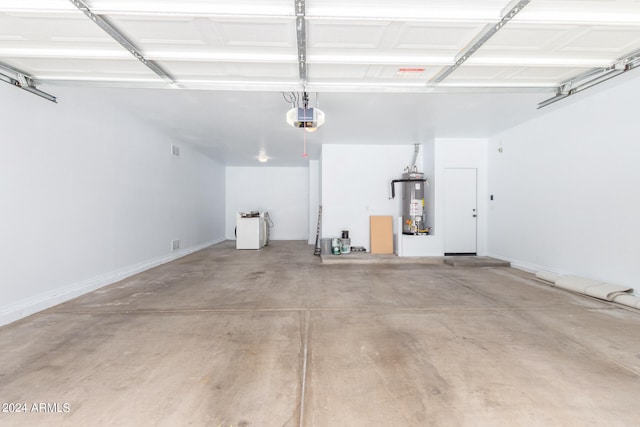 garage with washer / clothes dryer, a garage door opener, and water heater