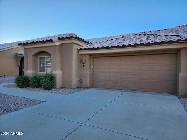 mediterranean / spanish-style house featuring a garage