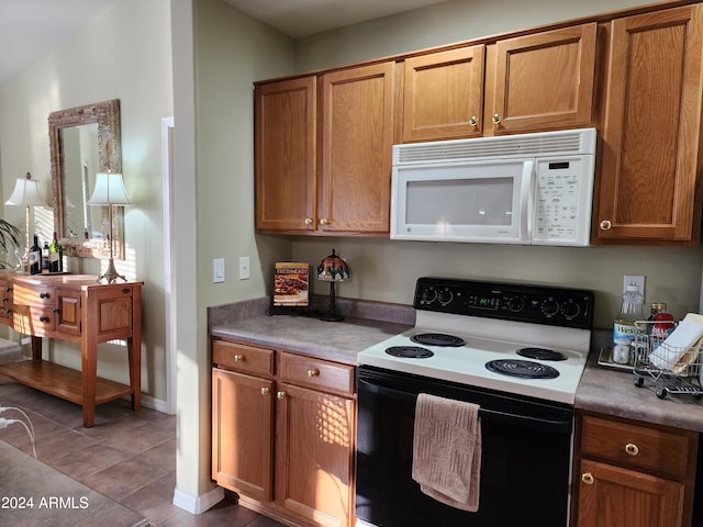 kitchen with tile patterned flooring and white appliances