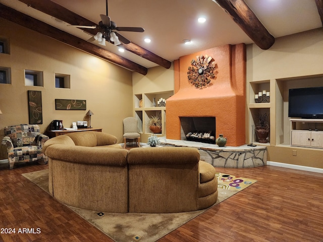 living room with beam ceiling, wood-type flooring, a fireplace, and ceiling fan