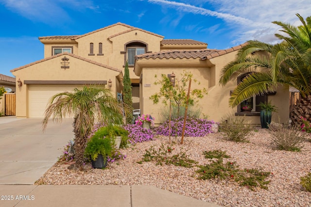 mediterranean / spanish home with a garage