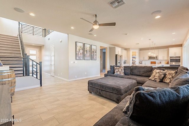 living area with baseboards, recessed lighting, stairs, visible vents, and ceiling fan