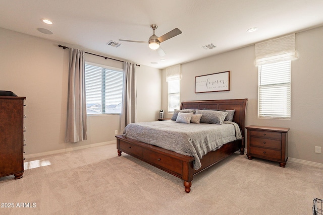 bedroom with light carpet, visible vents, and baseboards