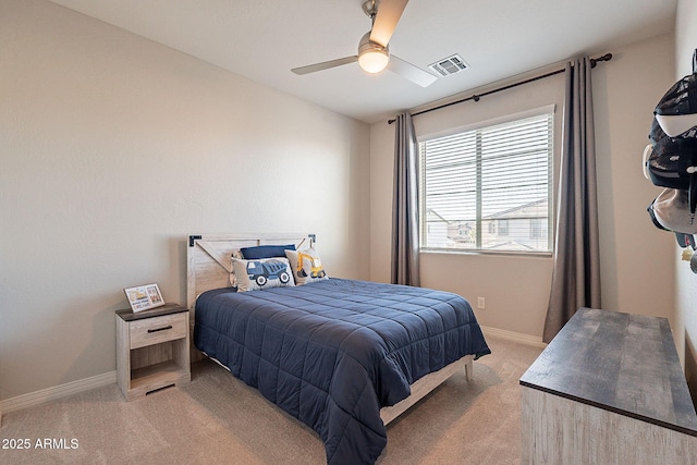 bedroom featuring visible vents, baseboards, ceiling fan, and light carpet