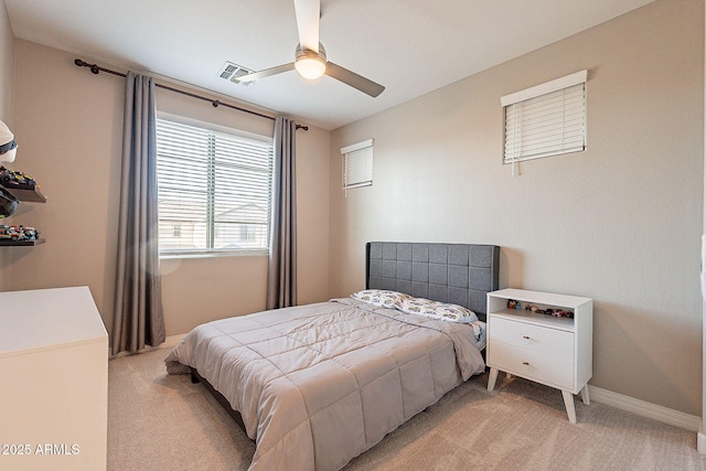 bedroom with visible vents, baseboards, a ceiling fan, and light carpet