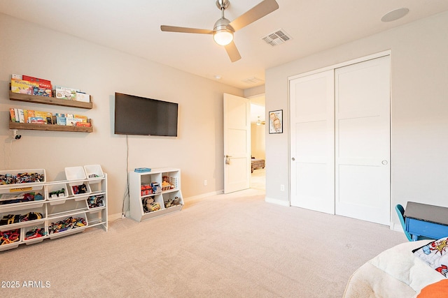 recreation room with ceiling fan, baseboards, carpet, and visible vents