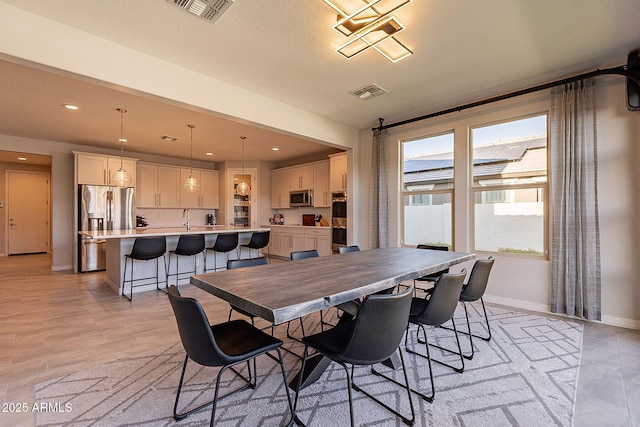 dining room with visible vents, baseboards, recessed lighting, and light wood-style floors