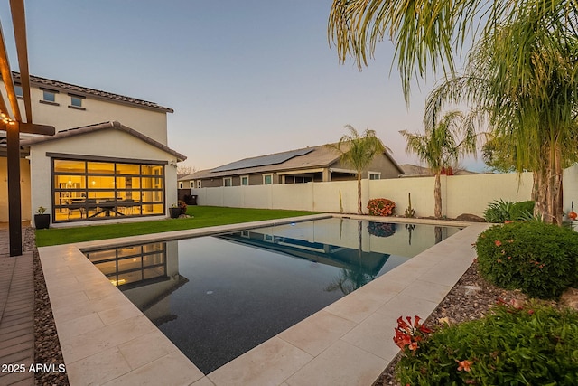 view of pool featuring a fenced in pool, a patio, a fenced backyard, and a lawn