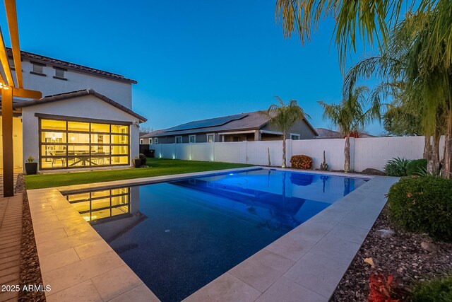 view of pool with a fenced in pool, a patio area, a fenced backyard, and a lawn