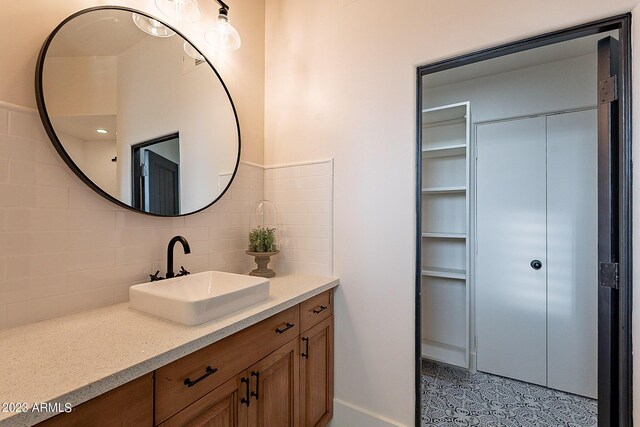 bathroom featuring vanity and tasteful backsplash