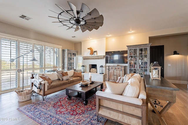 living room featuring ceiling fan and hardwood / wood-style floors